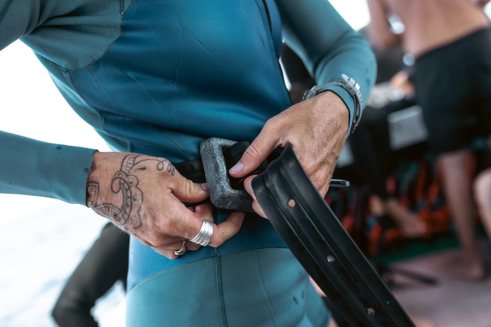 Freediver putting on weight belt.